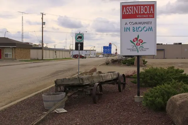Assiniboia welcome sign and old wagon